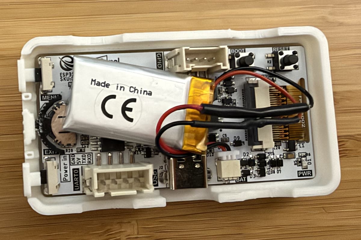 the CrowPanel board with a battery pouch attached, seated in the printed case base