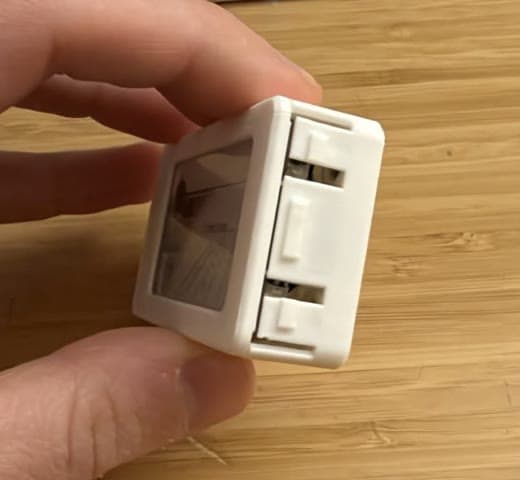 the living-hinge button flaps in the case wall